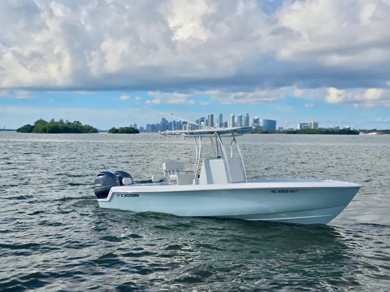 Slide: The Image of 2023 Contender Center Console boat on water with city skyline in background. - 5