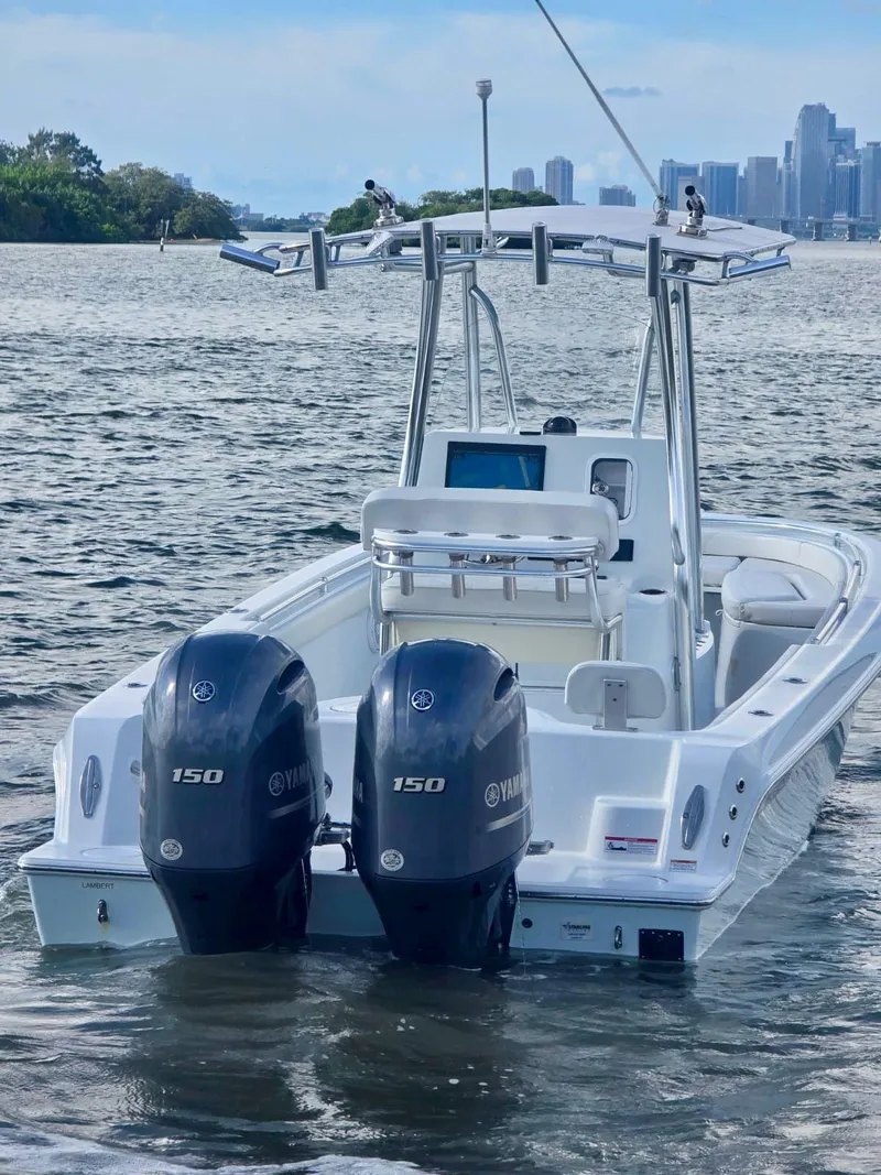 Slide: The Image of 2023 Contender Center Console boat with dual Yamaha 150 engines on the water. - 6