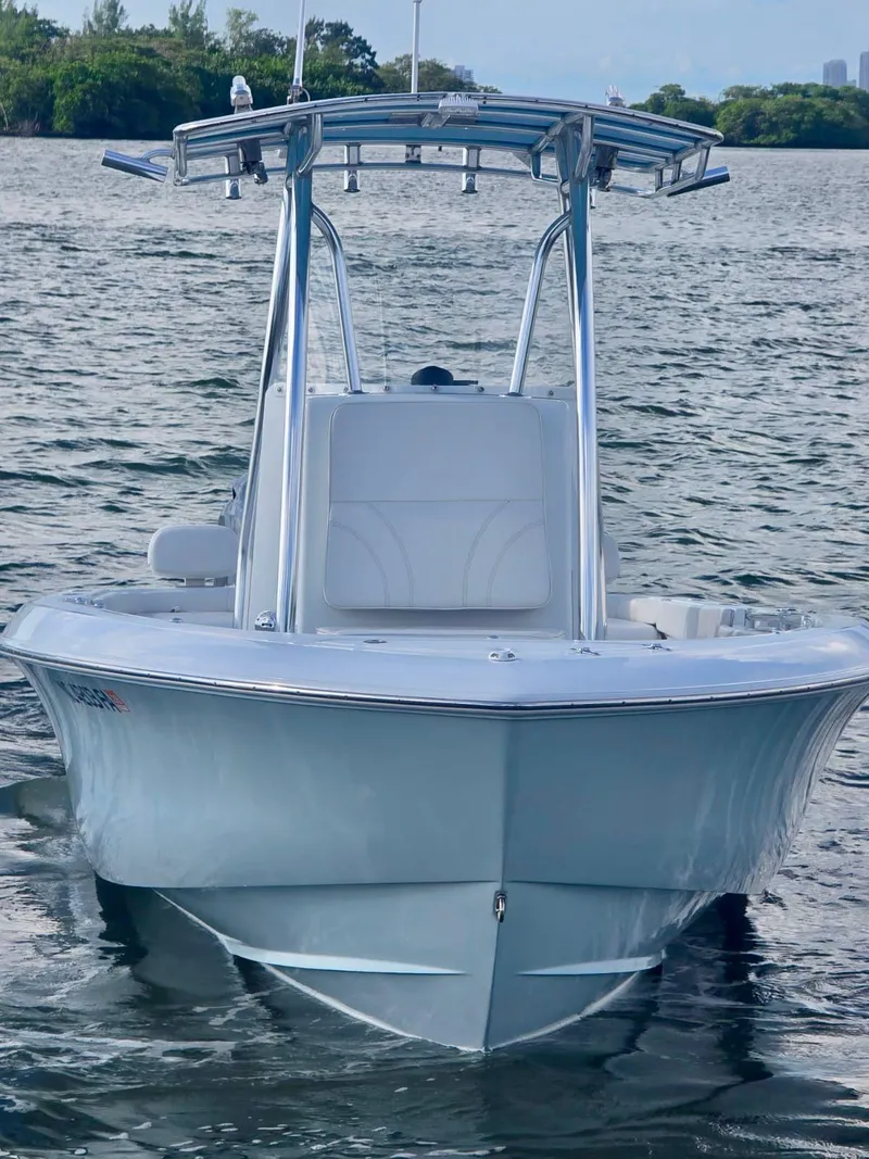 Slide: The Image of 2023 Contender Center Console boat on calm water, showcasing sleek design and modern features. - 8