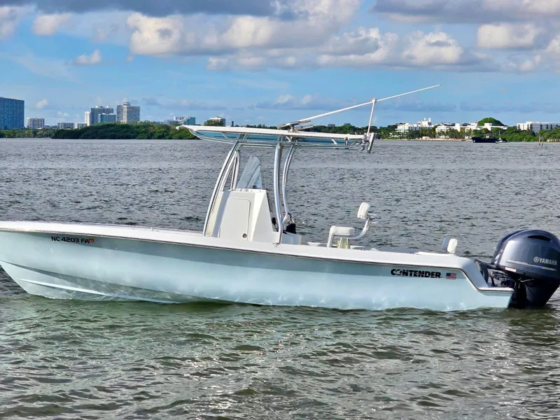 Slide: The Image of 2023 Contender Center Console boat on water with city skyline in background. - 9