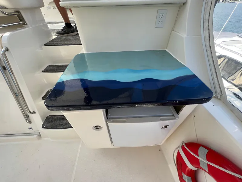 Slide: The Image of 2004 Silverton 39 Motor Yacht interior with a blue gradient table and life preserver. - 11