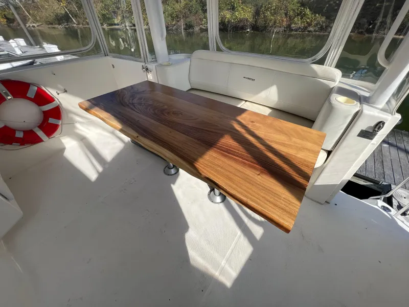 Slide: The Image of Luxurious 2004 Silverton 39 Motor Yacht interior with elegant wooden table and seating. - 13