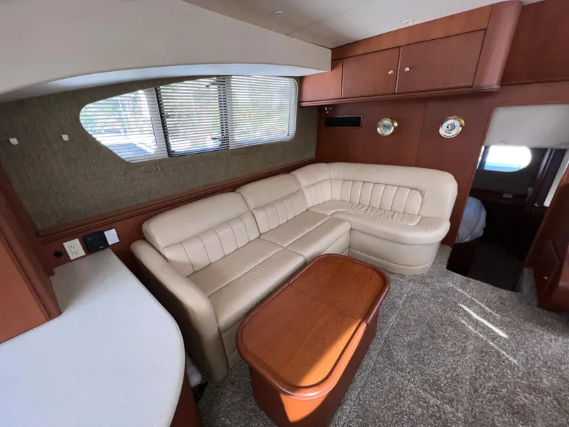 Slide: The Image of Luxurious interior of 2004 Silverton 39 Motor Yacht with beige leather seating and wooden accents. - 14