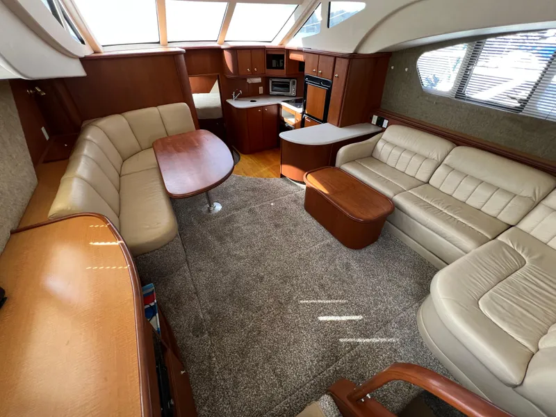 Slide: The Image of Luxurious interior of a 2004 Silverton 39 Motor Yacht with plush seating and wood accents. - 15