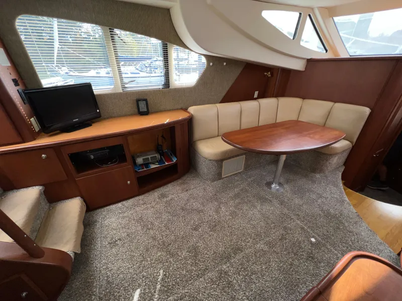 Slide: The Image of Interior of 2004 Silverton 39 Motor Yacht with cozy seating and entertainment area. - 16