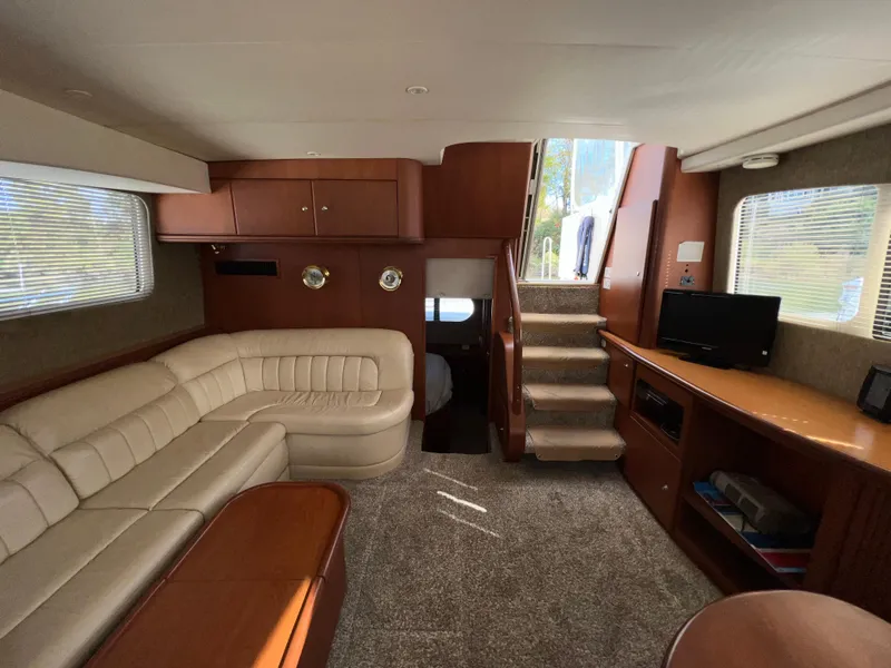 Slide: The Image of Interior of 2004 Silverton 39 Motor Yacht with beige seating and wooden cabinetry. - 17
