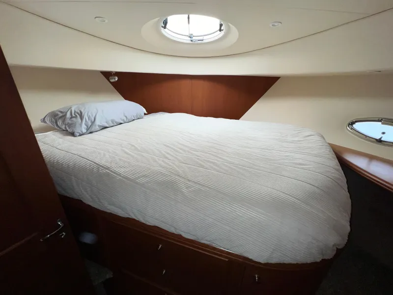 Slide: The Image of Luxurious cabin interior of 2004 Silverton 39 Motor Yacht with cozy bed and porthole. - 18