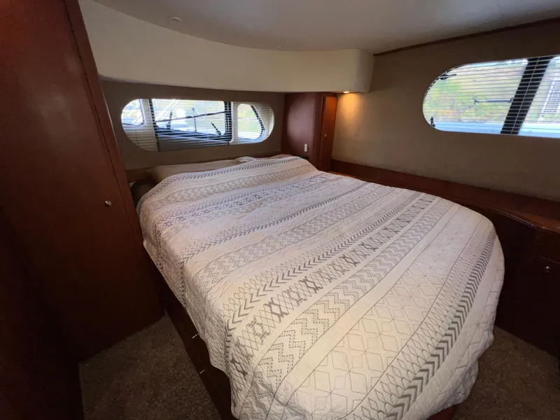 Slide: The Image of Luxurious bedroom interior of 2004 Silverton 39 Motor Yacht with large bed and windows. - 20