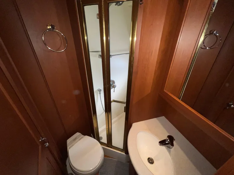 Slide: The Image of 2004 Silverton 39 Motor Yacht bathroom with shower, sink, and toilet. - 22