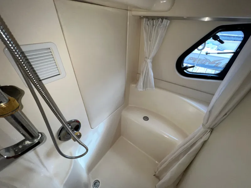 Slide: The Image of 2004 Silverton 39 Motor Yacht bathroom with shower and window. - 23