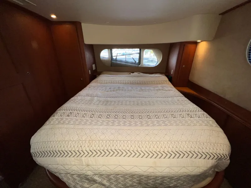 Slide: The Image of Luxurious bedroom interior of 2004 Silverton 39 Motor Yacht with cozy bedding. - 25