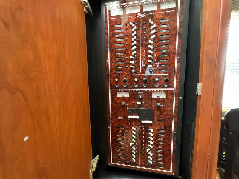 Slide: The Image of Electrical control panel inside 2004 Silverton 39 Motor Yacht, featuring switches and dials. - 28