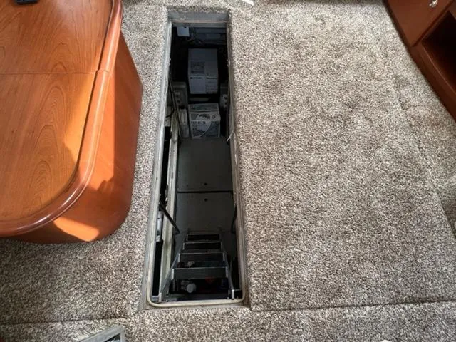 Slide: The Image of Engine compartment access on 2004 Silverton 39 Motor Yacht with carpeted flooring. - 29