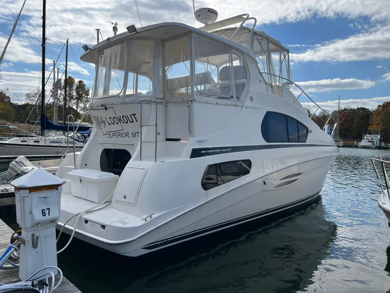 Slide: The Image of 2004 Silverton 39 Motor Yacht docked at marina under blue sky. - 3