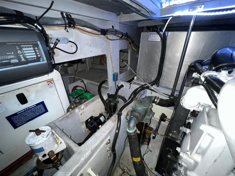 Slide: The Image of Engine room of 2004 Silverton 39 Motor Yacht, showcasing mechanical components and wiring. - 37