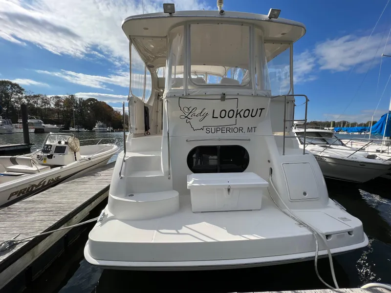 Slide: The Image of 2004 Silverton 39 Motor Yacht docked, named "Lady Lookout," in a marina setting. - 4
