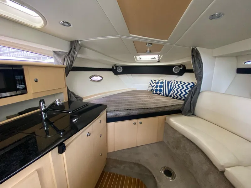 Slide: The Image of Luxurious interior of 2015 Bayliner 335 Cruiser with kitchenette and cozy seating area. - 11