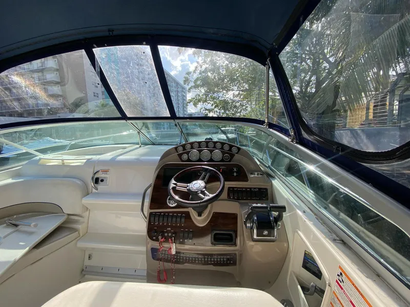 Slide: The Image of Interior view of 2015 Bayliner 335 Cruiser boat cockpit with steering wheel and controls. - 12