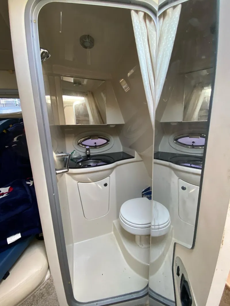 Slide: The Image of 2015 Bayliner 335 Cruiser bathroom with mirror, sink, and toilet. - 5