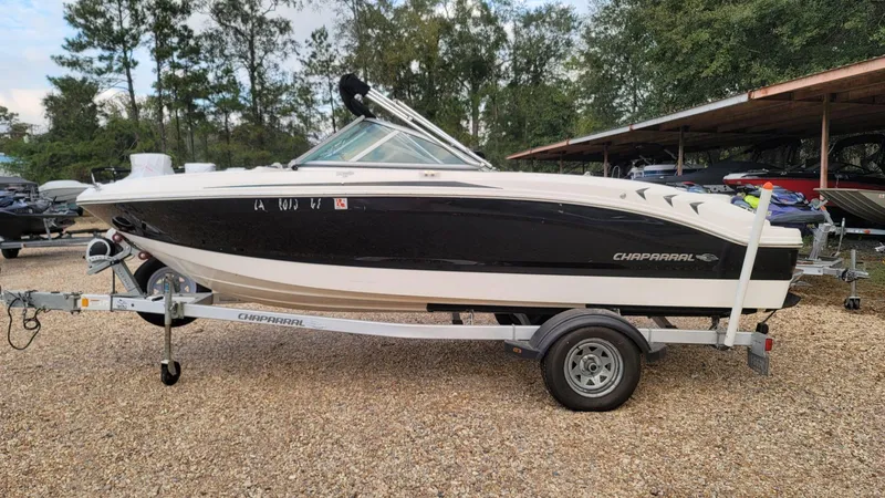 Slide: The Image of 2016 Chaparral 19 H2O Sport boat on trailer, parked outdoors. - 10
