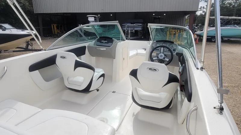 Slide: The Image of 2016 Chaparral 19 H2O Sport boat interior with white and black seating. - 13