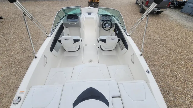 Slide: The Image of 2016 Chaparral 19 H2O Sport boat interior with seating and steering wheel. - 15