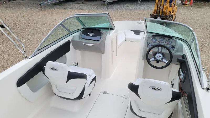 Slide: The Image of 2016 Chaparral 19 H2O Sport boat interior with steering wheel and seating. - 16