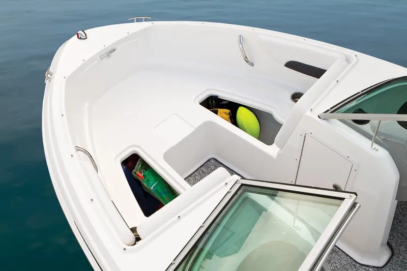 Slide: The Image of 2016 Chaparral 19 H2O Sport boat interior with open storage compartments. - 22