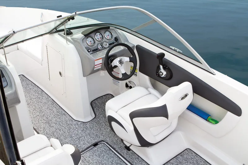 Slide: The Image of 2016 Chaparral 19 H2O Sport boat interior with steering wheel and dashboard. - 23