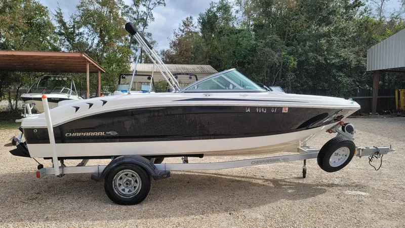 Slide: The Image of 2016 Chaparral 19 H2O Sport boat on trailer, parked outdoors. - 5
