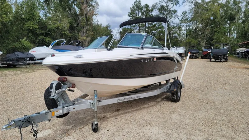 Slide: The Image of 2016 Chaparral 19 H2O Sport boat on trailer, parked outdoors. - 8