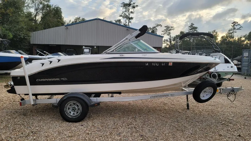 Slide: The Image of 2016 Chaparral 19 H2O Sport boat on trailer, parked outdoors. - 9