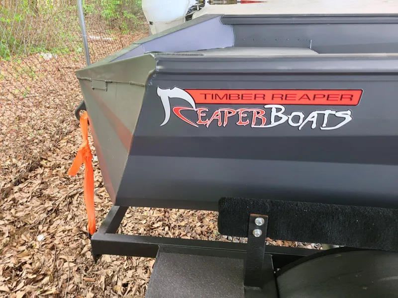 Slide: The Image of 2024 Reaper Boats 550, Timber Reaper model, parked outdoors. - 3