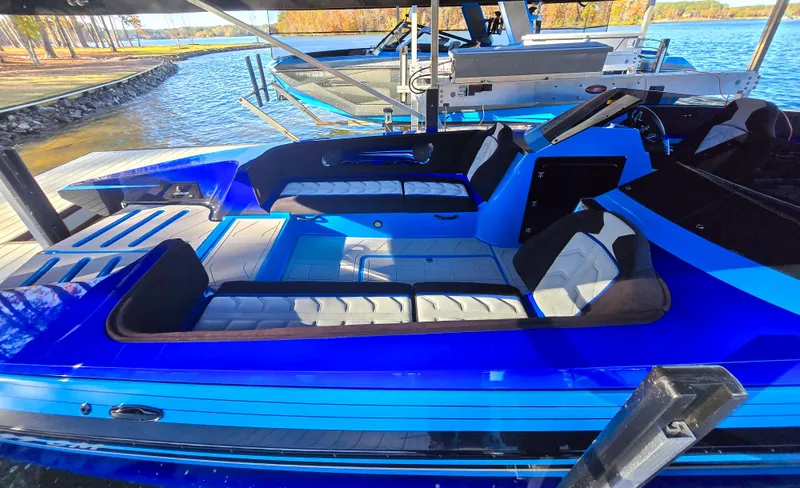 Slide: The Image of 2023 Howard 288 Sport Deck boat with blue exterior, docked by a serene lake. - 117