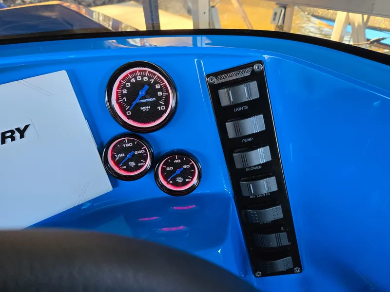 Slide: The Image of Dashboard of 2023 Howard 288 Sport Deck with gauges and control switches. - 159