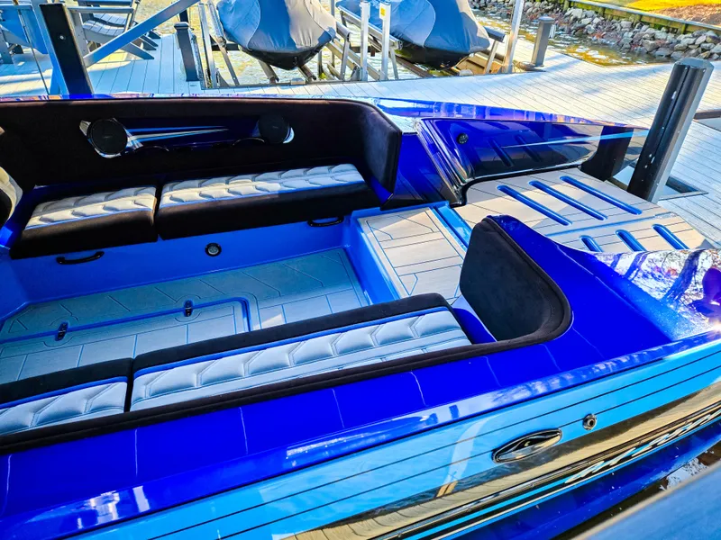 Slide: The Image of 2023 Howard 288 Sport Deck boat with sleek blue interior and spacious seating. - 98