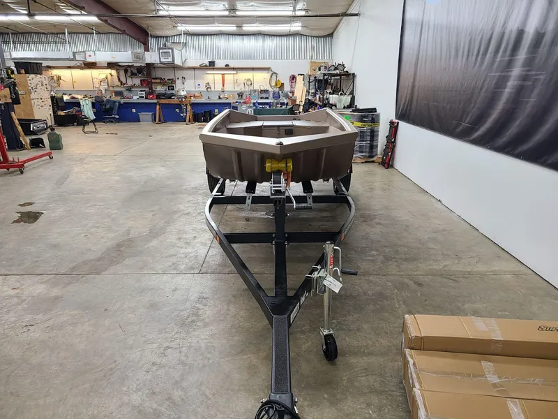 Slide: The Image of 2024 Reaper Boats 550 on trailer in workshop setting. - 2