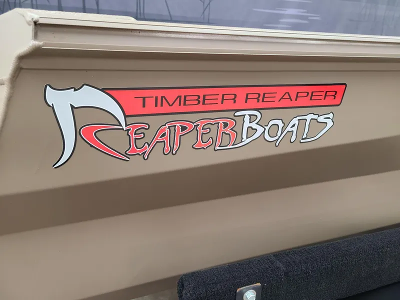 Slide: The Image of 2024 Reaper Boats 550 logo on boat exterior, featuring "Timber Reaper" branding. - 4