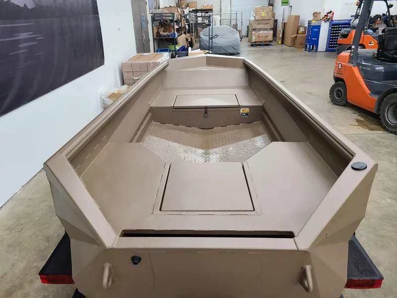 Slide: The Image of 2024 Reaper Boats 550 in warehouse, showcasing interior design and storage compartments. - 6