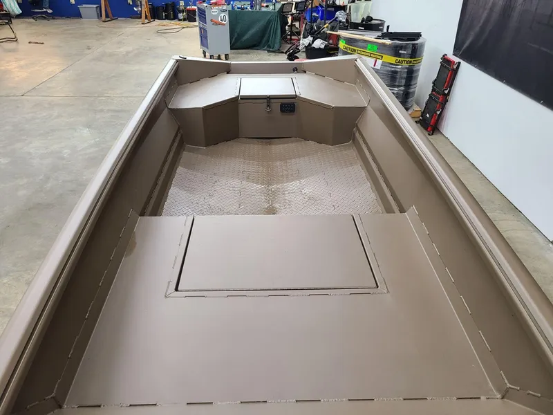 Slide: The Image of 2024 Reaper Boats 550 interior view in a workshop setting. - 8