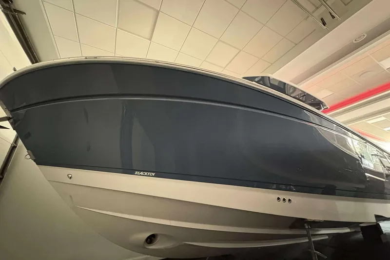Slide: The Image of 2025 Blackfin 302 CC boat in showroom, showcasing sleek design and modern features. - 1