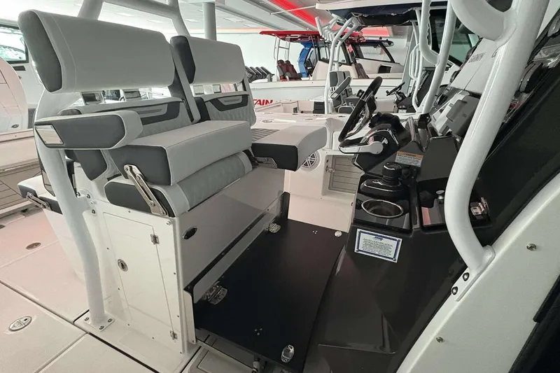 Slide: The Image of 2025 Blackfin 302 CC boat interior with modern seating and control console. - 10