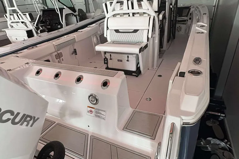 Slide: The Image of 2025 Blackfin 302 CC boat interior with seating and fishing rod holders. - 13