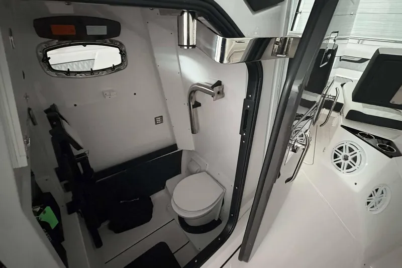 Slide: The Image of Interior of 2025 Blackfin 302 CC boat featuring a compact bathroom with modern amenities. - 15