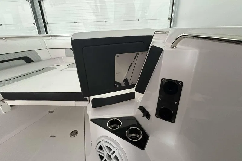 Slide: The Image of 2025 Blackfin 302 CC boat interior with seating, cup holders, and speaker. - 16