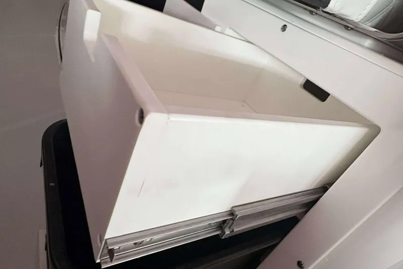 Slide: The Image of White storage compartment in a 2025 Blackfin 302 CC boat. - 20