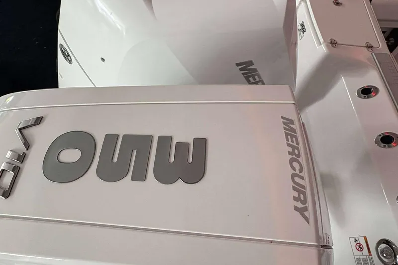 Slide: The Image of 2025 Blackfin 302 CC boat with Mercury engine branding, close-up view. - 21
