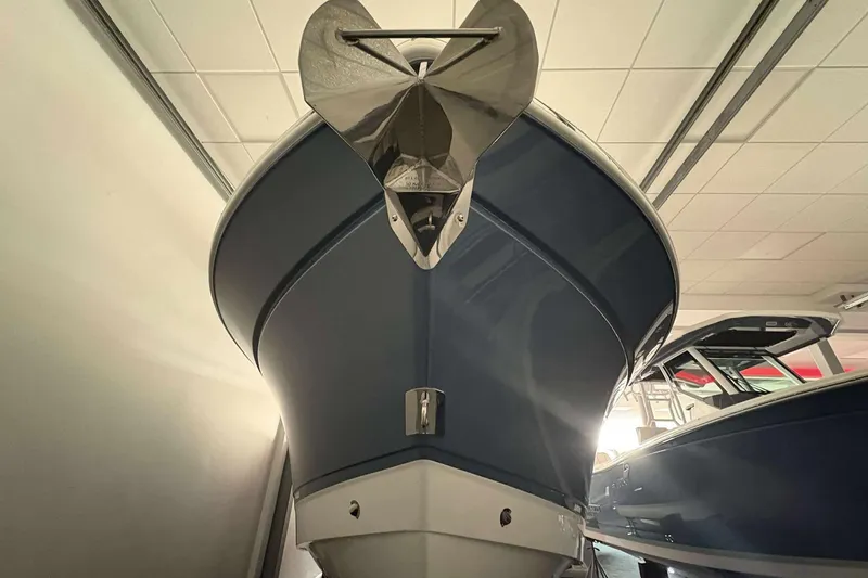 Slide: The Image of 2025 Blackfin 302 CC boat in showroom, viewed from the front with anchor visible. - 4