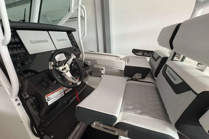 Slide: The Image of 2025 Blackfin 302 CC boat interior with Garmin displays and modern seating. - 9