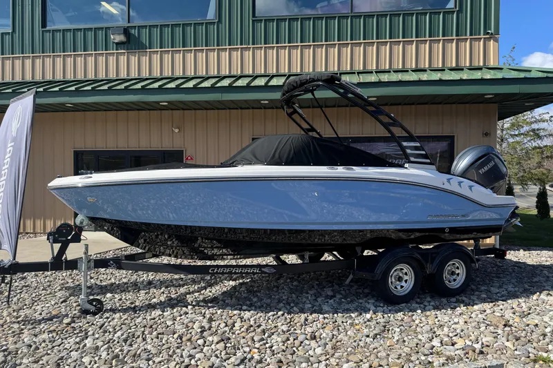 The Image of 2025 Chaparral 21 SSi OB boat on trailer, parked outside a building. - 0